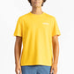 picture of a man wearing a Sun Yellow tee shirt with manana branding and blue shorts