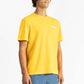 picture of a man wearing a Sun Yellow tee shirt with manana branding and blue shorts