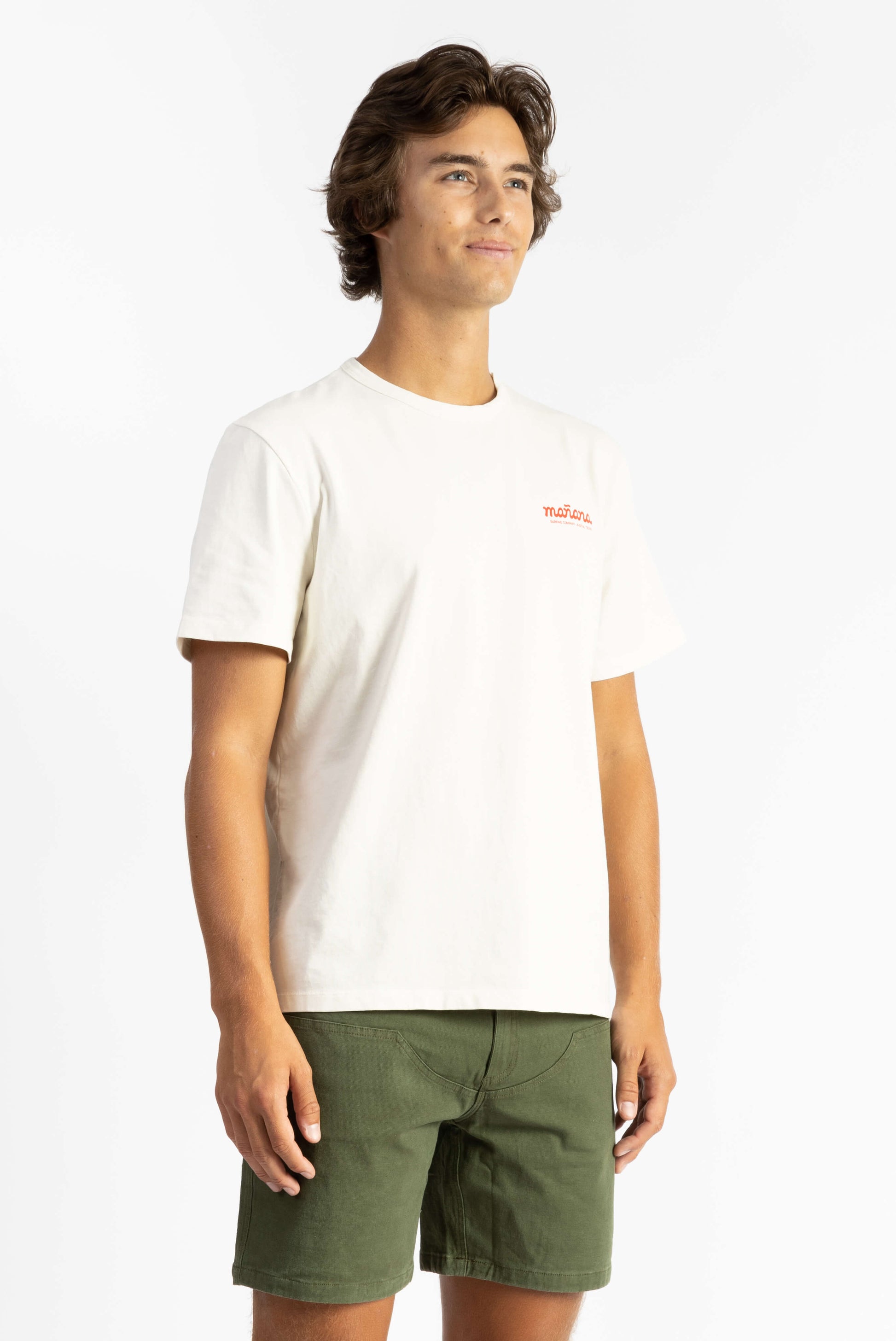 picture of a man wearing an off-white tee shirt with manana branding and green shorts