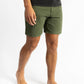 A man wearing an Olive color work shorts with a black shirt