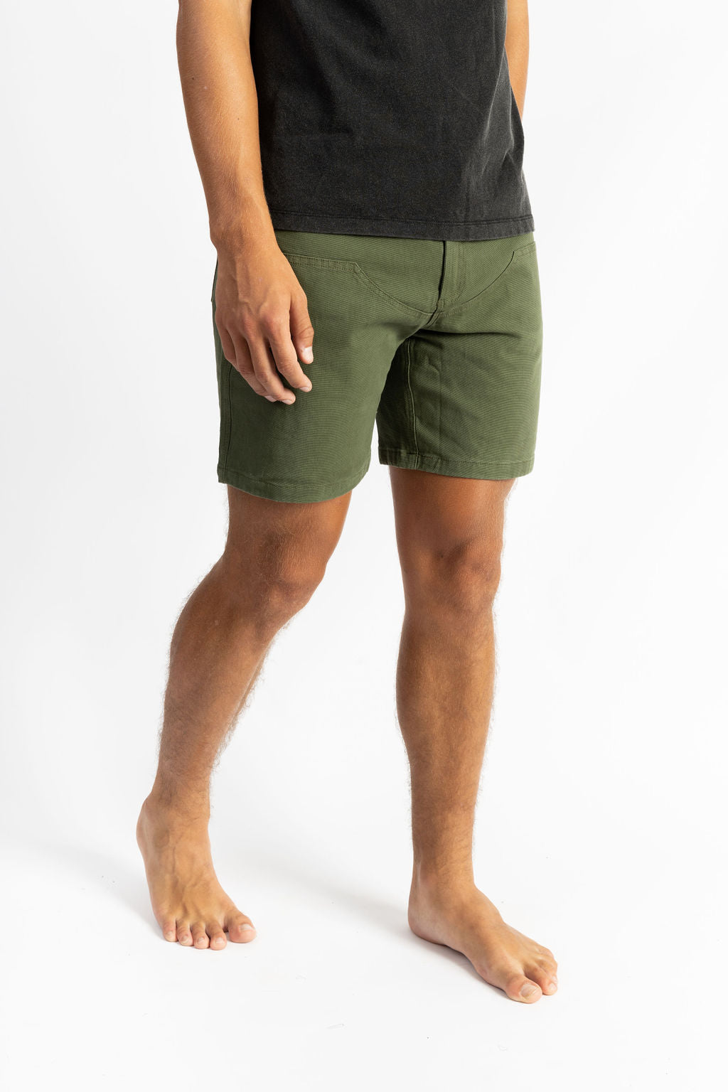 A man wearing an Olive color work shorts with a black shirt
