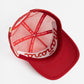 a picture of red mesh hat with Manana written on it