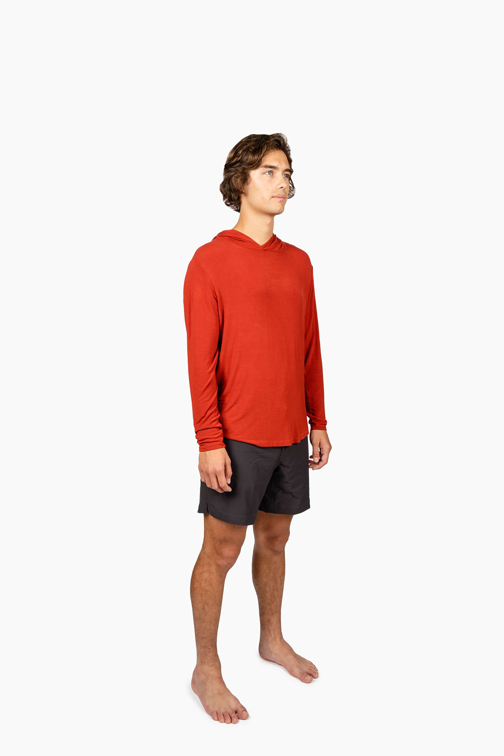 A man wearing a Red Sun Shirt with black shorts