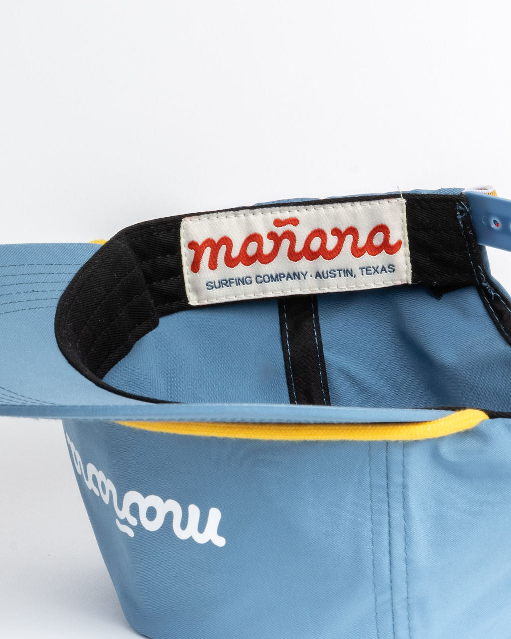 a blue classis cap with Manana branding