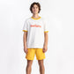 A man wearing an Off-White tee shirt having Manana branding with yellow shorts