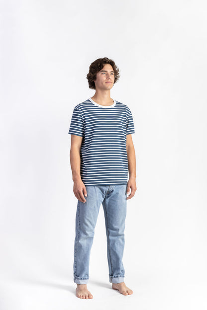 A man wearing a Blue/White Striped Tee Shirt with light blue jeans